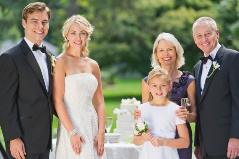 Portrait of married couple, parents and flower girl (10-11).