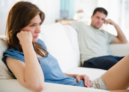 Couple on sofa having relationship problems. Photo : Jamie Grill