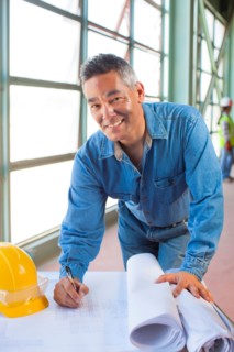 Portrait of architect drawing blueprint. Photo : db2stock