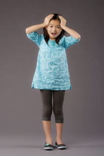 Portrait of smiling girl (8-9), studio shot. Photo : Rob Lewine
