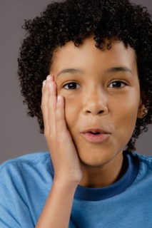 Portrait of surprised boy (8-9), studio shot. Photo : Rob Lewine