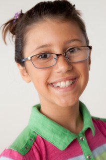 Studio portrait of girl (8-9) wearing eyeglasses. Photo : Rob Lewine