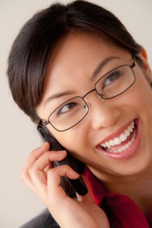 Studio portrait of businesswoman talking on cell phone. Photo : Rob Lewine