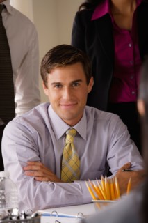 Portrait of smiling businessman in office. Photo : Rob Lewine