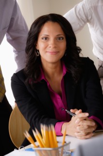 Portrait of smiling businesswoman at business meeting. Photo : Rob Lewine
