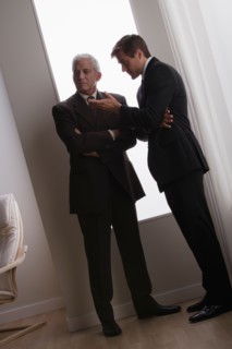 Two business men discussing in office. Photo : Rob Lewine