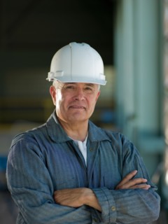 Portrait of industrial worker wearing hardhat. Photo : db2stock