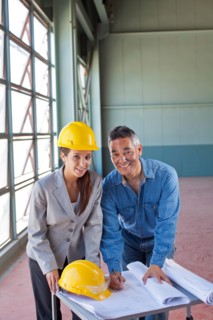 Portrait of architects drawing blueprint. Photo : db2stock