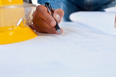 Architect's hand drawing blueprint. Photo : db2stock