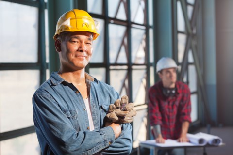 Portrait of worker wearing hardhat. Photo : db2stock
