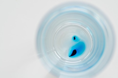 Studio shot of laboratory beaker with blue liquid. Photo : Antonio M. Rosario