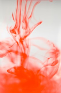 Studio shot of red liquid dissolving in water. Photo : Antonio M. Rosario