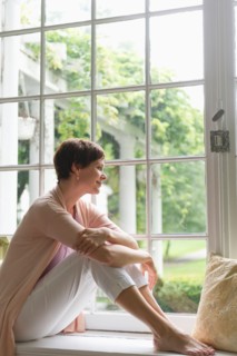 Woman looking through window.