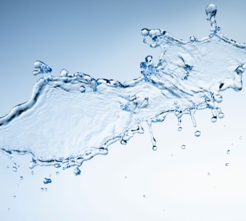 Studio shot of water splash on blue background.