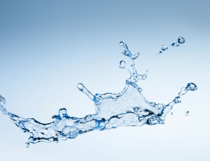 Studio shot of water splash on blue background.