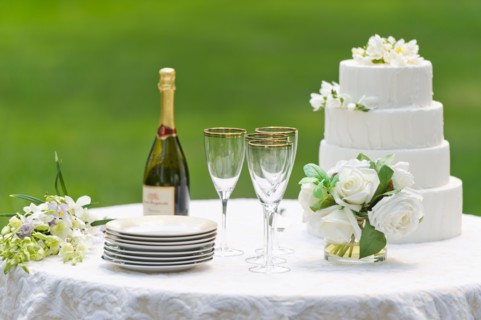Table with champagne bottle and wedding cake.
