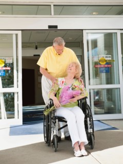 Senior people going out from hospital.