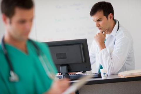 Doctor looking at computer.