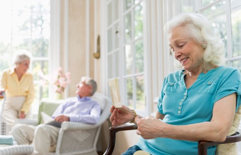 Senior woman reading greeting card.