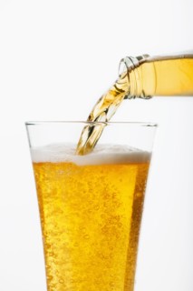 Beer pouring into glass, studio shot.