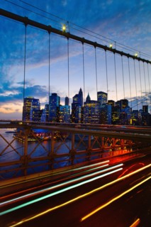 USA, New York State, New York City, Lower Manhattan and Brooklyn Bridge at dusk.