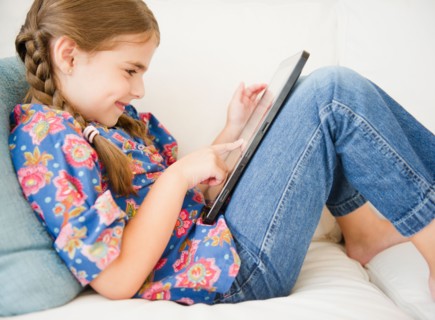 Girl ( 6-7) using digital tablet. Photo : Jamie Grill
