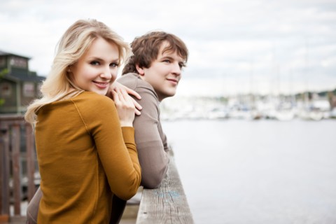 USA, Washington, Seattle, Young couple on pier, woman looking at camera. Photo : Take A Pix Media