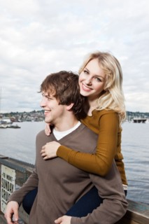 USA, Washington, Seattle, Young couple on pier, woman looking at camera. Photo : Take A Pix Media