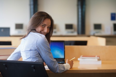 Portrait of female student studying in library. Photo: Jan Scherders