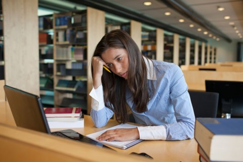 Female student studying in library. Photo : Jan Scherders