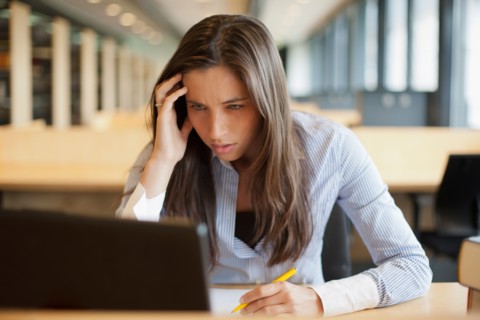 Female student studying in library. Photo : Jan Scherders