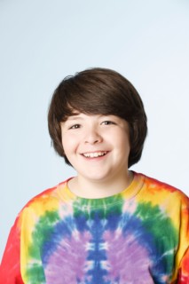 Studio portrait of boy (10-11) in colorful shirt. Photo : Rob Lewine