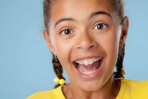 Studio portrait of girl (10-11) laughing. Photo : Rob Lewine