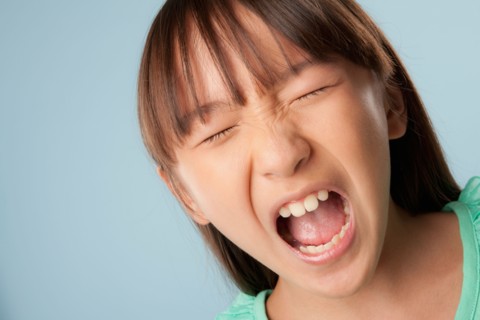 Studio portrait of girl (10-11) shouting. Photo: Rob Lewine