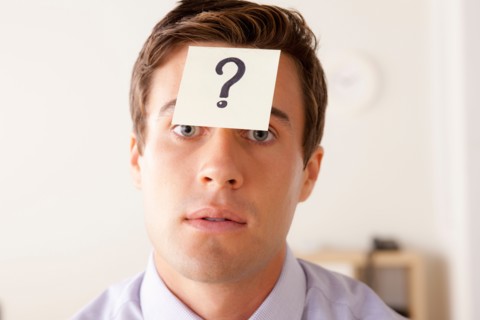 Portrait of businessman with adhesive note attached on forehead. Photo : Rob Lewine