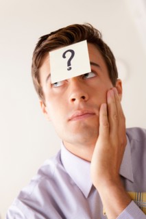 Portrait of businessman with adhesive note attached on forehead. Photo : Rob Lewine