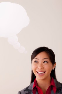 Studio portrait of businesswoman with thought bubble. Photo : Rob Lewine