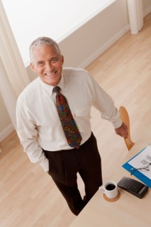 Portrait of smiling senior businessman. Photo: Rob Lewine