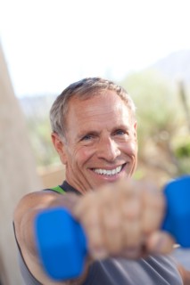 Portrait of senior man lifting dumbbells. Photo : db2stock