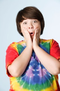 Studio portrait of boy (10-11) in colorful shirt. Photo : Rob Lewine