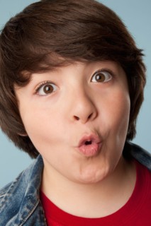 Studio portrait of boy (10-11) making a face. Photo : Rob Lewine