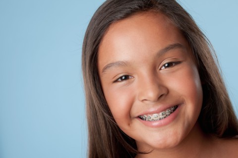 Studio portrait of girl smiling (10-11). Photo : Rob Lewine