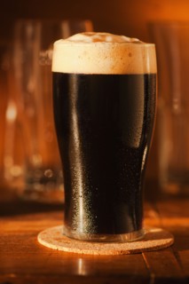 Ale in beer glass on bar counter.
