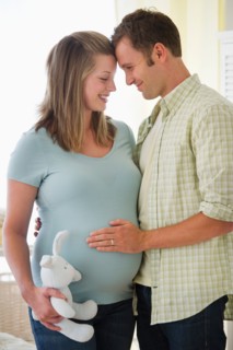 Young couple standing in nursery.