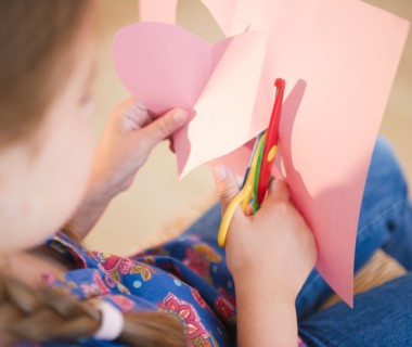 Girl ( 6-7) cutting heart shape for valentine's day. Photo : Jamie Grill