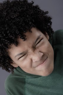 Portrait of boy (8-9) looking angry, studio shot. Photo : Rob Lewine