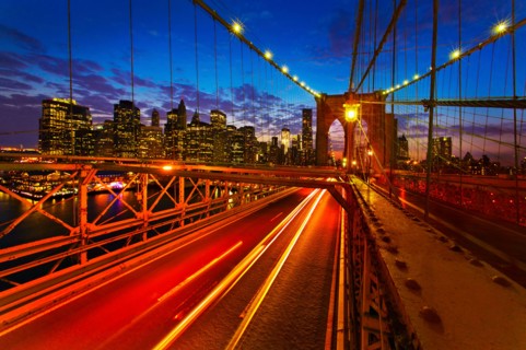 USA, New York City, Brooklyn Bridge with light trails at dusk.