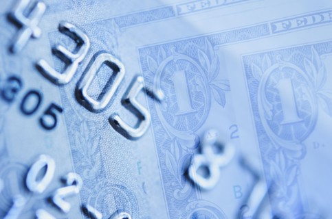 Credit card and dollar bills, studio shot.