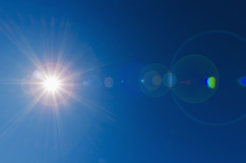 Blue sky with solar flare.