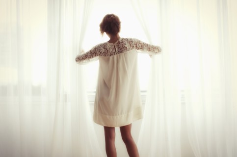 Woman looking out window.